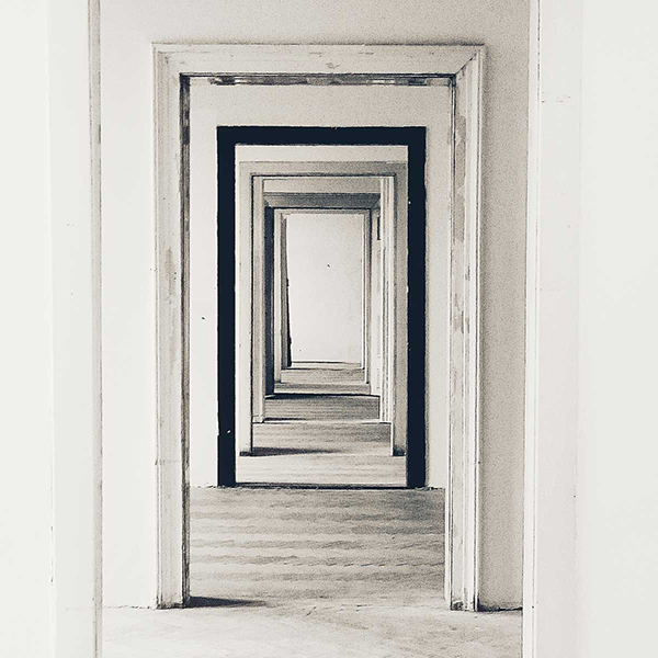 A view through a number of lined up white door frames.